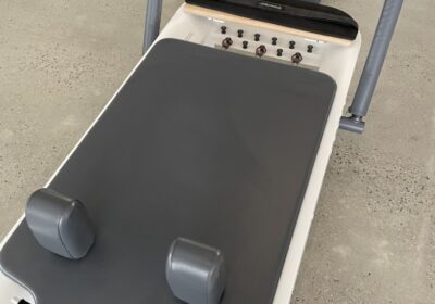 Reformer Allegro 2 full photo with carriage and spring set at front of Reformer and foot bar in up position
