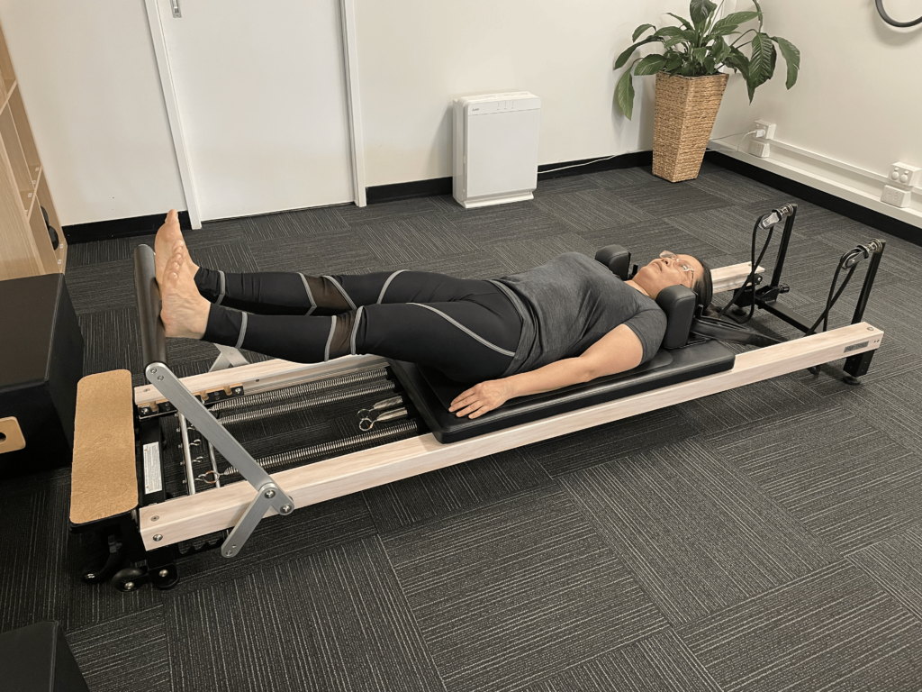 Original photo Legs in straps bringing both legs to the floor together