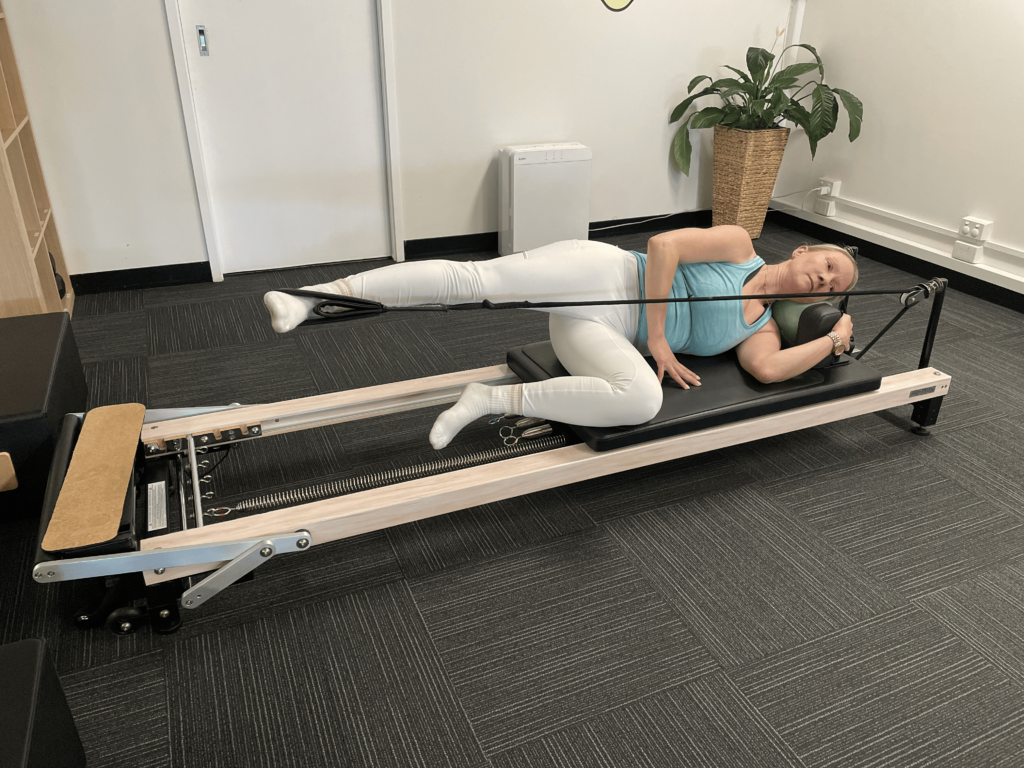 Original photo Side lying leg work - leg fully extended towards foot bar